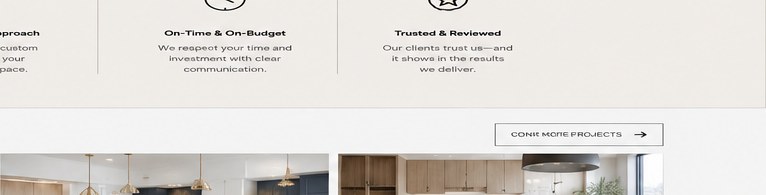 Warm modern kitchen interior with wood cabinetry, stone island and pendant lights
